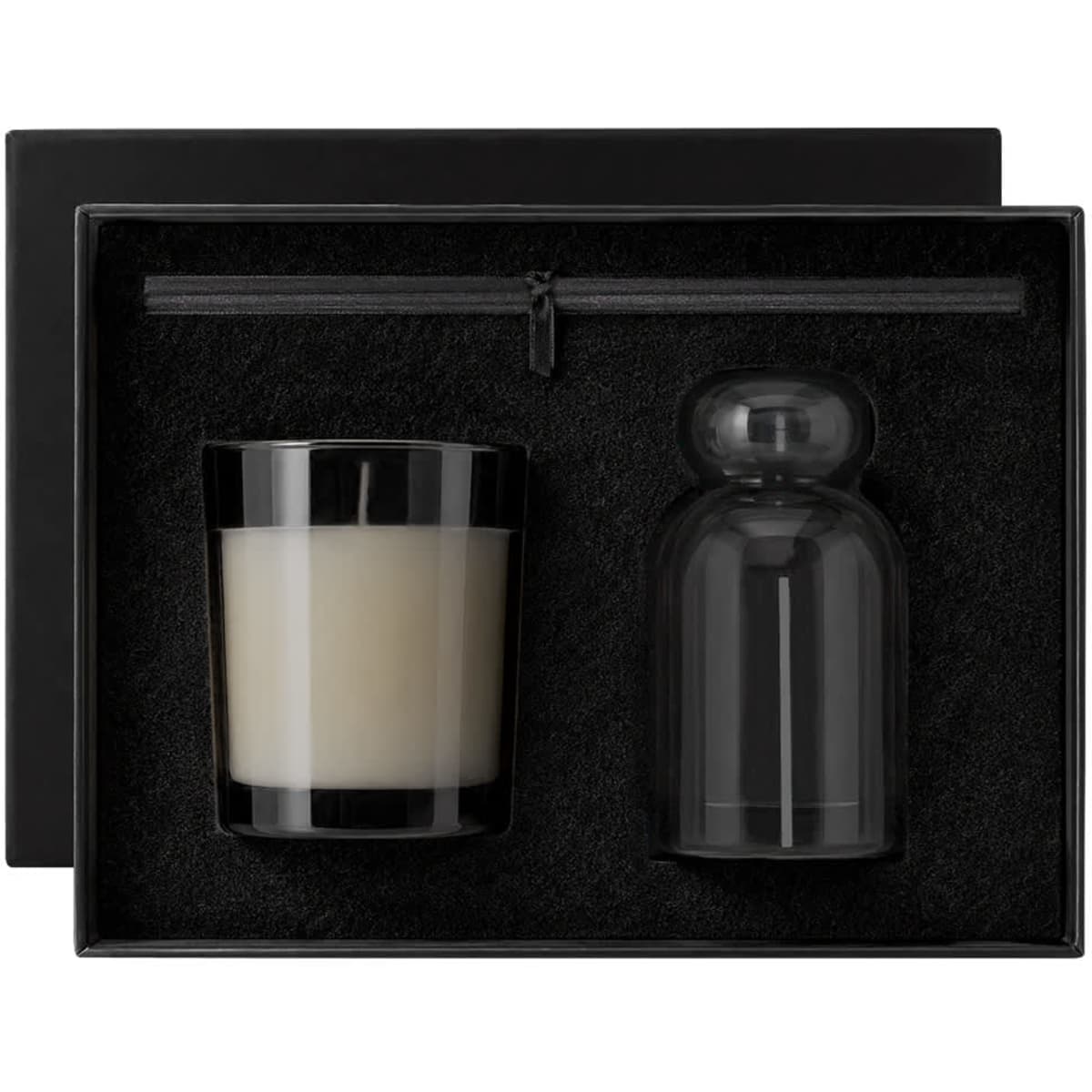 A gift set featuring a black candle and a glass cloche, presented in a sleek black box with a soft interior.