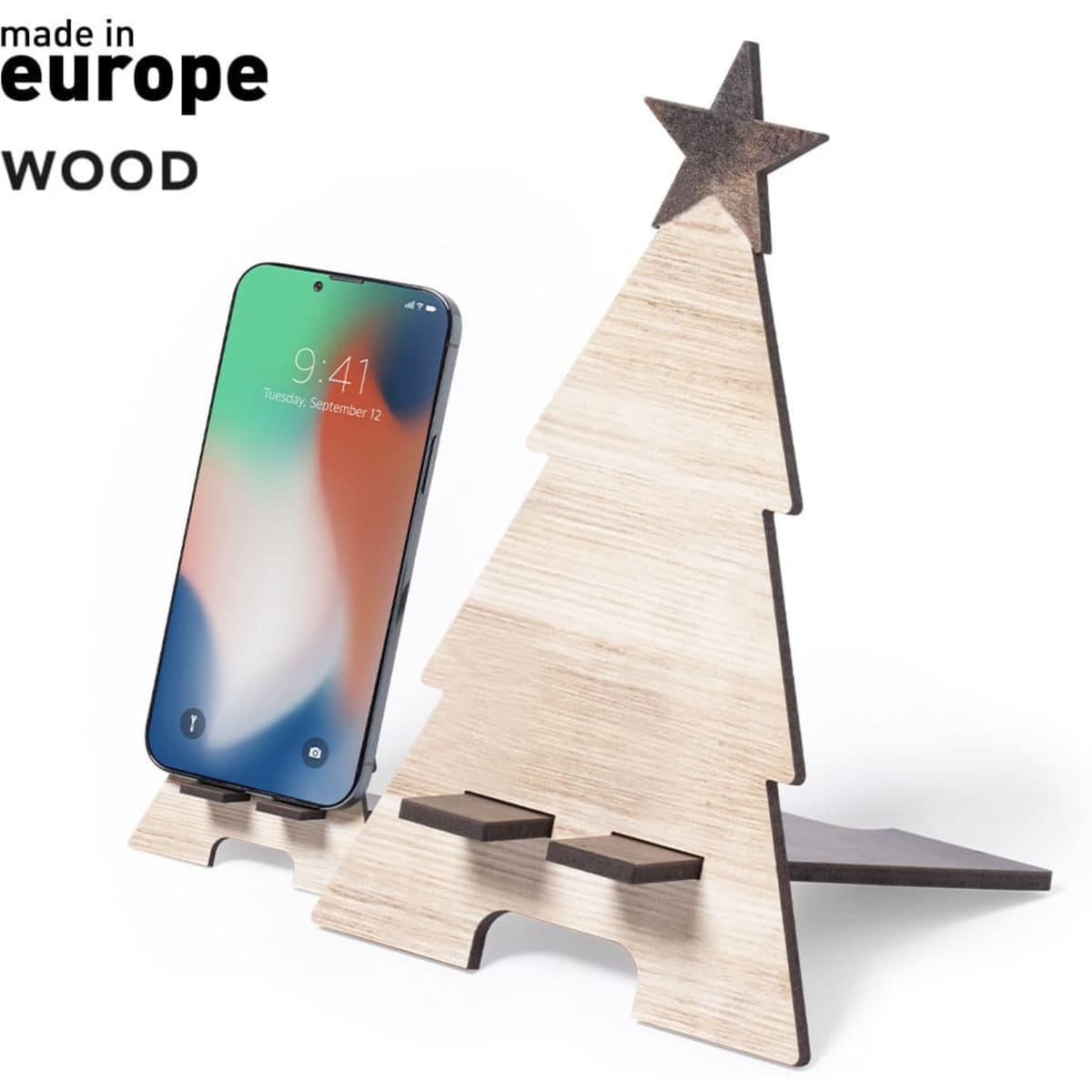 A wooden phone stand shaped like a Christmas tree, featuring a star on top and a space for a mobile device.
