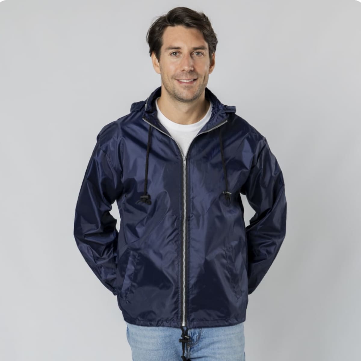 A navy rain jacket featuring a hood and drawstrings, worn by a smiling man. The jacket has a logo.