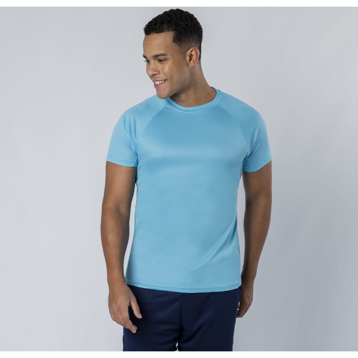 A fitted teal T-shirt with short sleeves, featuring a logo on the chest, displayed on a smiling male model.