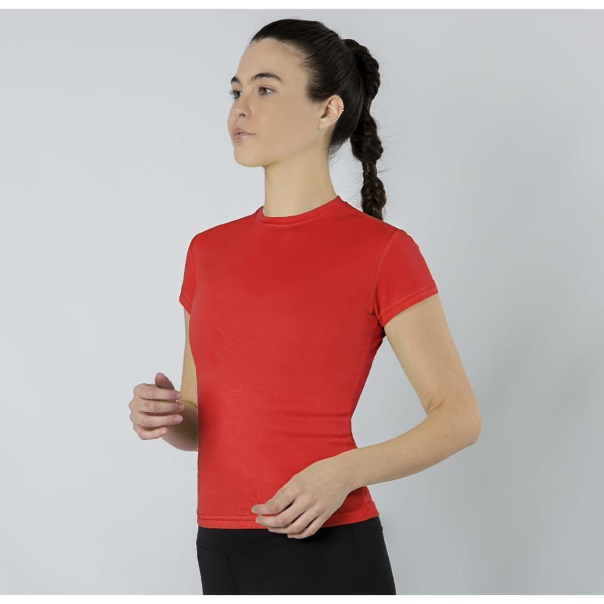 A fitted red T-shirt with short sleeves, featuring a logo. The model stands in a neutral pose against a plain background.