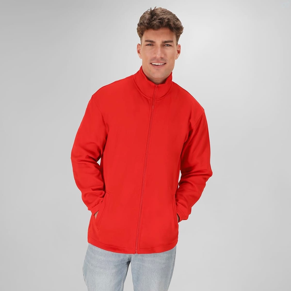 A red Klusten Jacket with a zip front and side pockets, displayed on a model against a grey background.