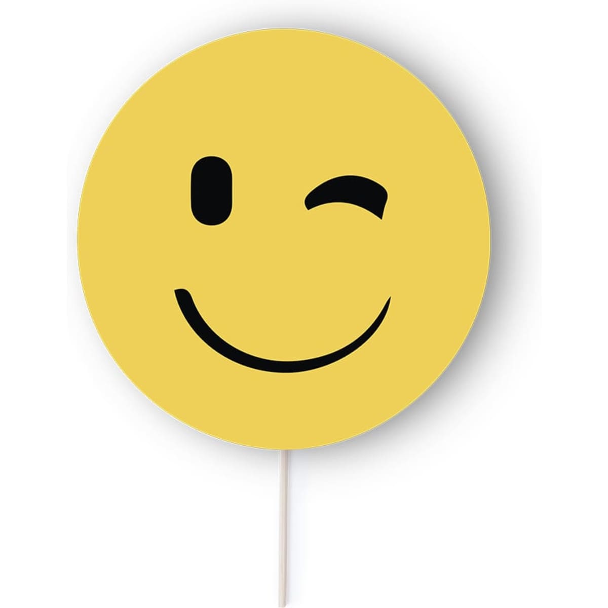 A yellow smiley face cutout with a wink, featuring a simple black smile and eye, mounted on a stick.