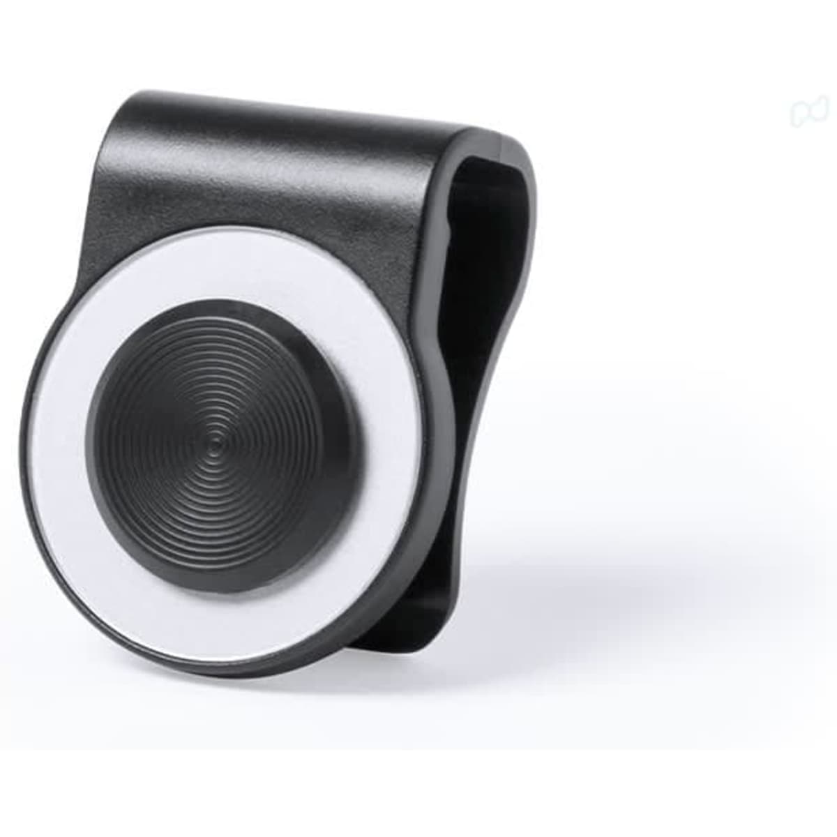 A black and white tech accessory with a circular design and a clip. It features a smooth, textured surface.