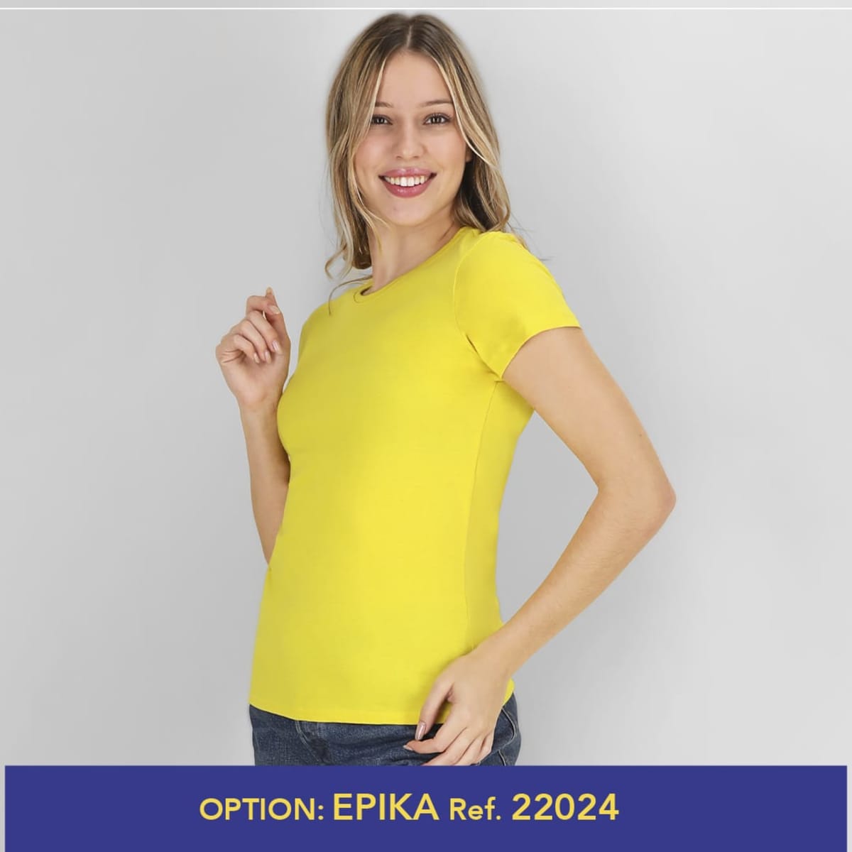 A fitted yellow T-shirt with short sleeves, featuring a logo. The model is posing with a smile.