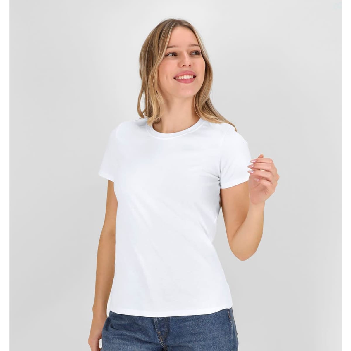 A white T-shirt with a fitted design, shown on a smiling model, paired with blue jeans. The shirt has a logo.