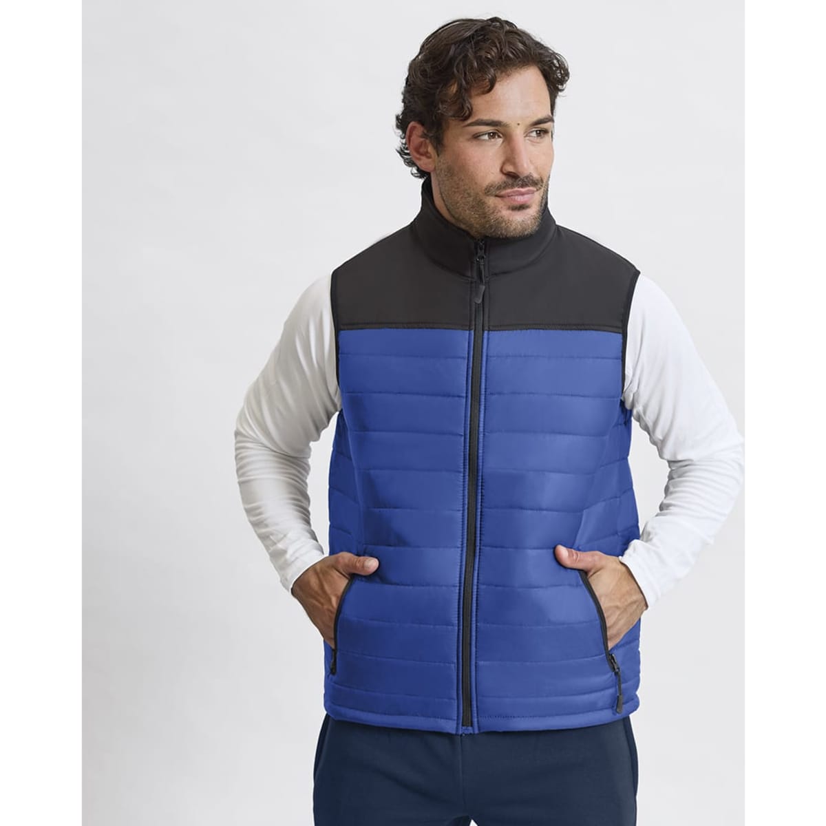 A blue vest with a black collar, featuring a zip front and two side pockets, worn by a model.