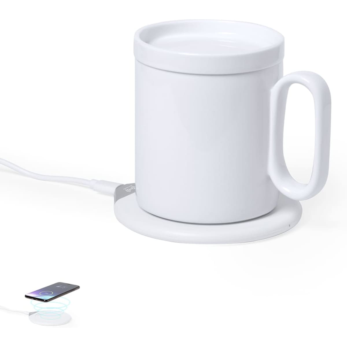 A white mug with a handle sits on a wireless charging pad, alongside a smartphone. The mug has a smooth surface.
