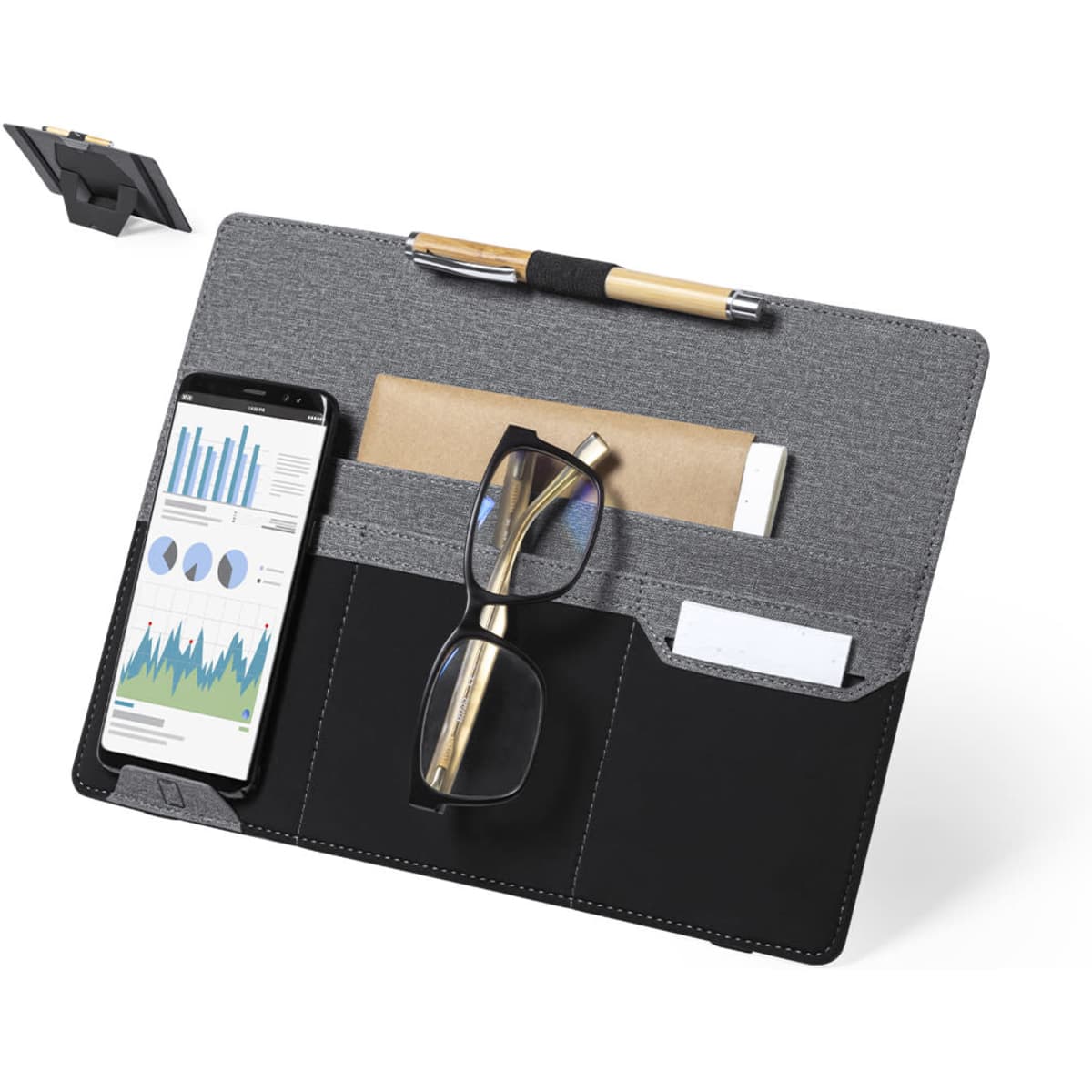 A grey and black organiser with compartments for a phone, glasses, a pen, and a notepad, featuring a stand and branding.