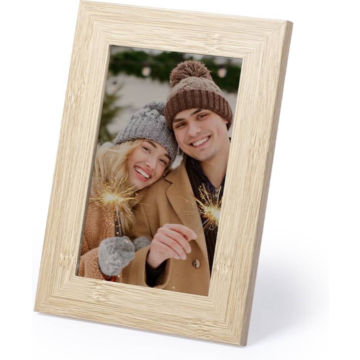 A wooden photo frame in light tones, displaying a happy couple holding sparklers outdoors.