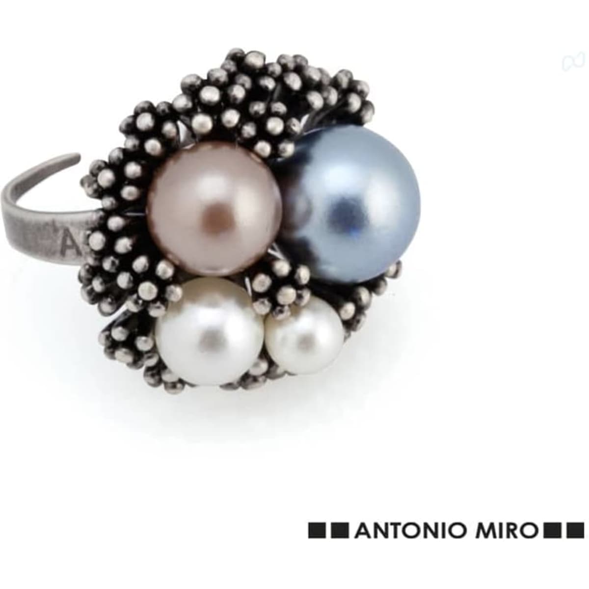 An adjustable ring featuring clusters of pearls in shades of pink, blue, and white, set in a textured silver design.