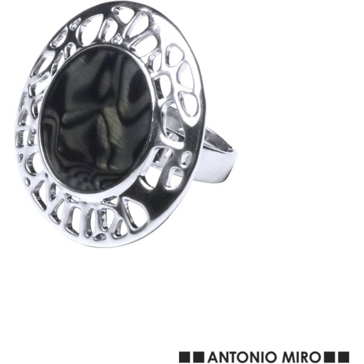 A silver ring with a circular design and a dark, reflective centre, featuring an intricate cut-out pattern.