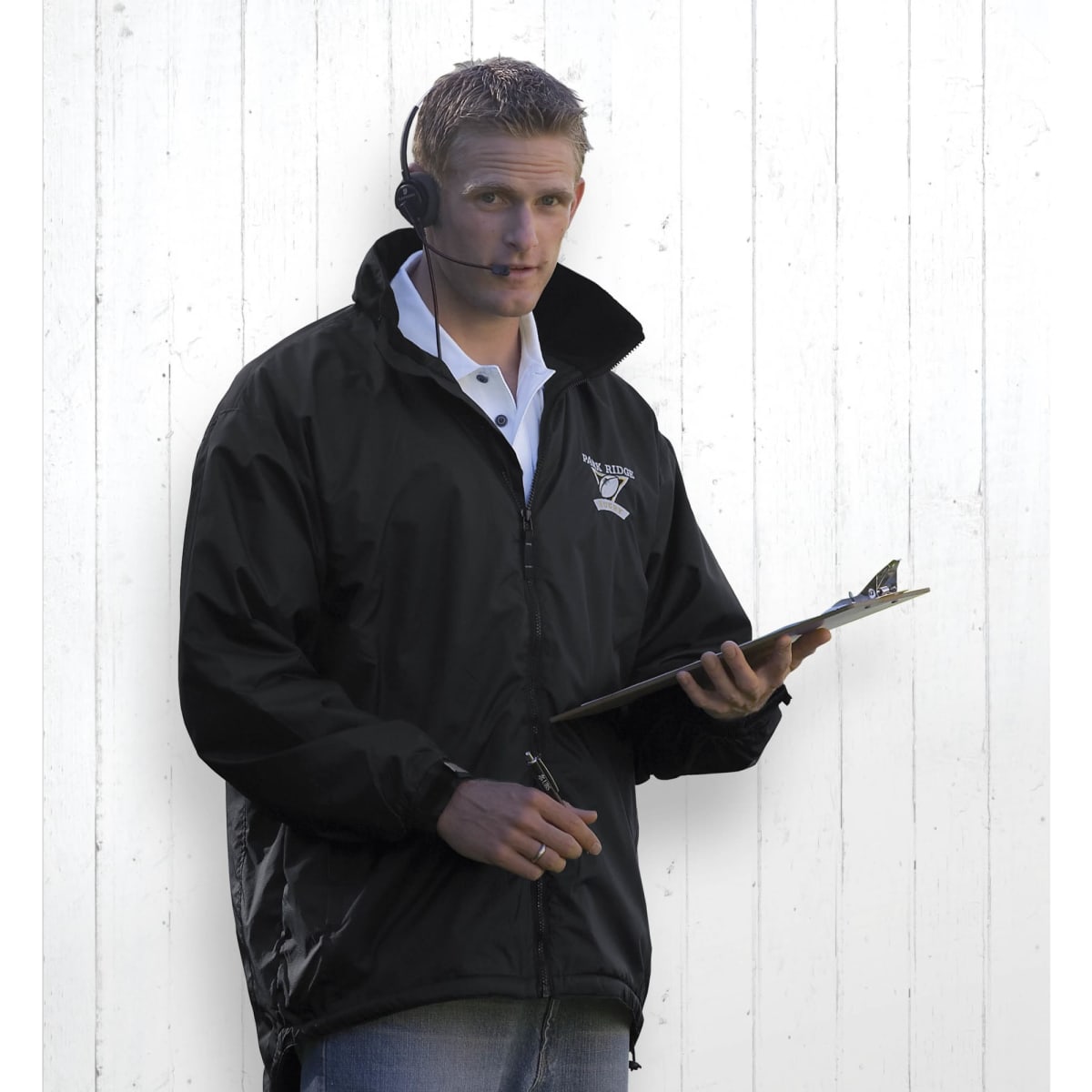 A black Manager's Jacket worn by a man holding a clipboard, with an earpiece and casual attire.
