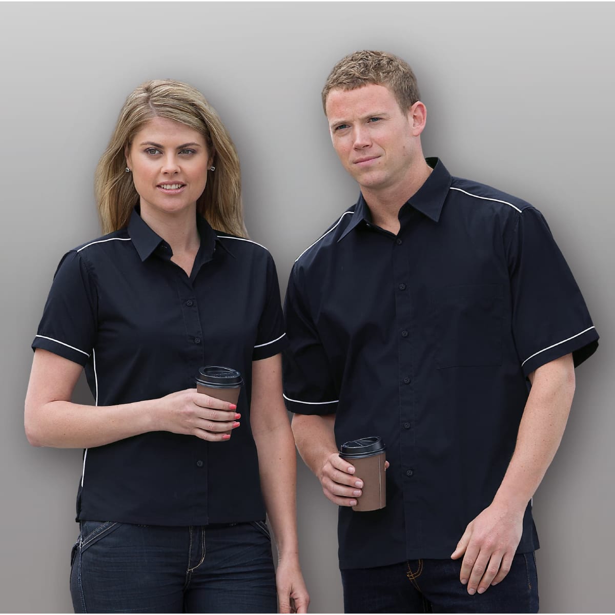 A navy button-up shirt for women, featuring white piping details, with two models holding drink cups.
