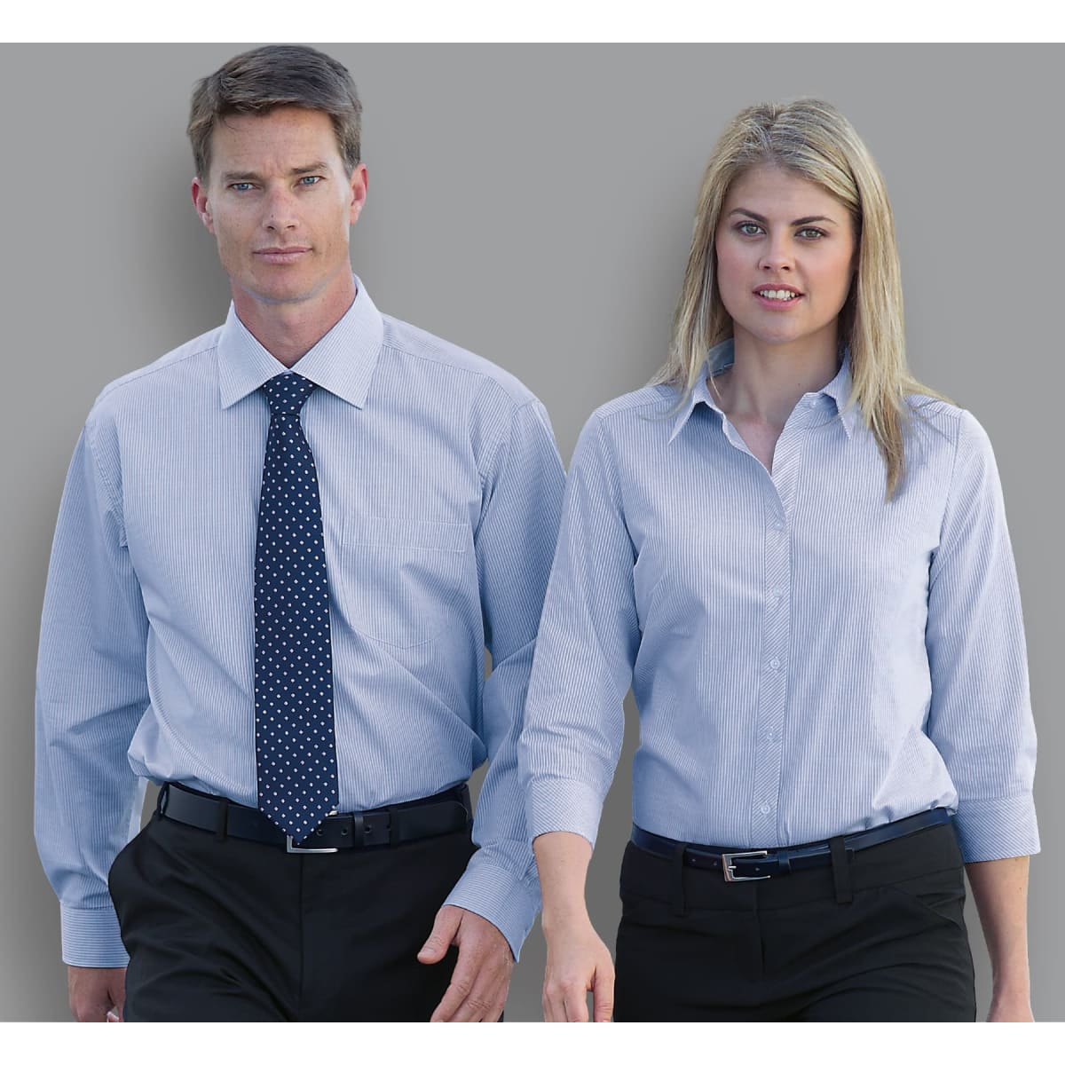 A button-up shirt for women in light blue, featuring a sleek design and a logo.