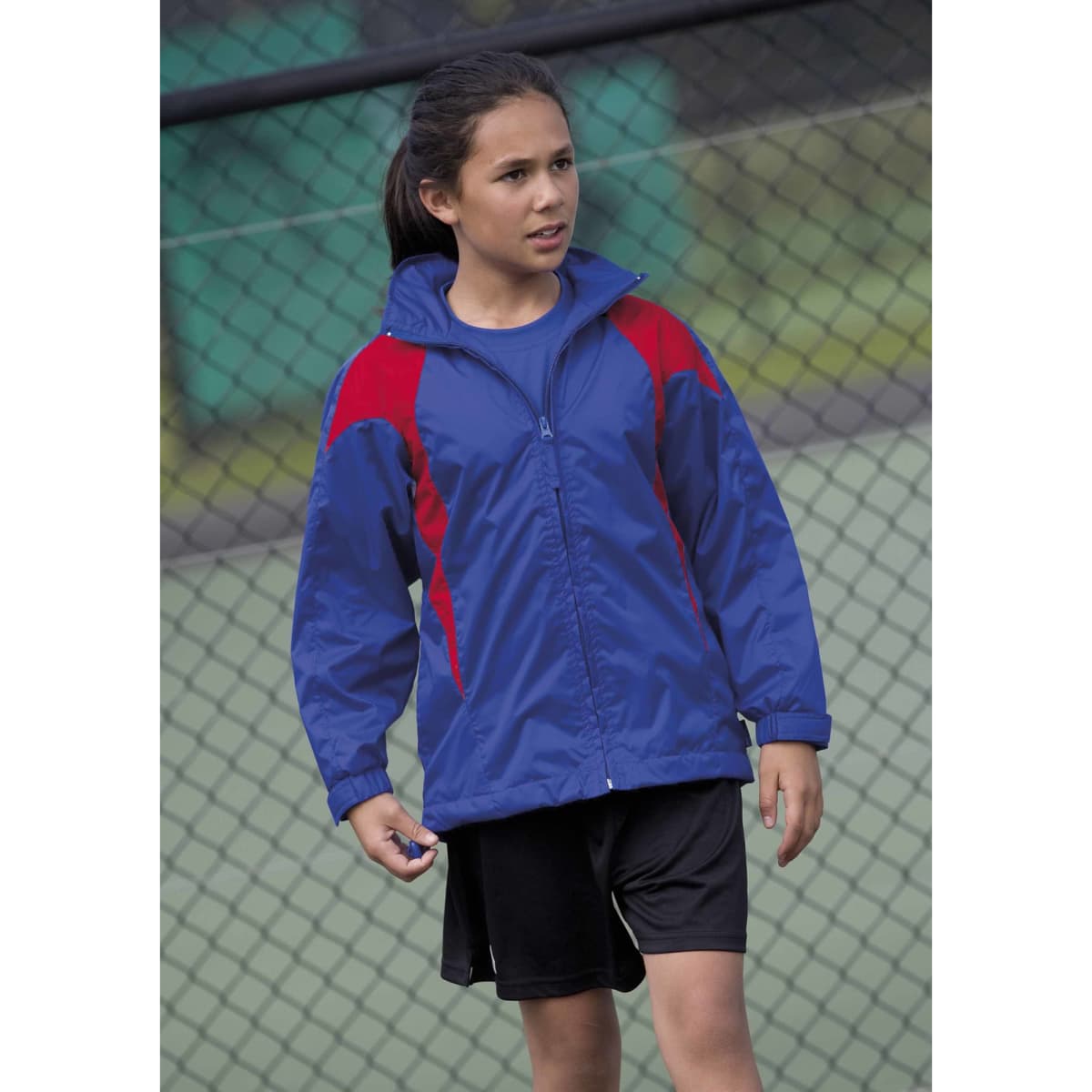 A blue jacket with red accents, featuring a front zip and a casual style, worn by a girl on a sports court.