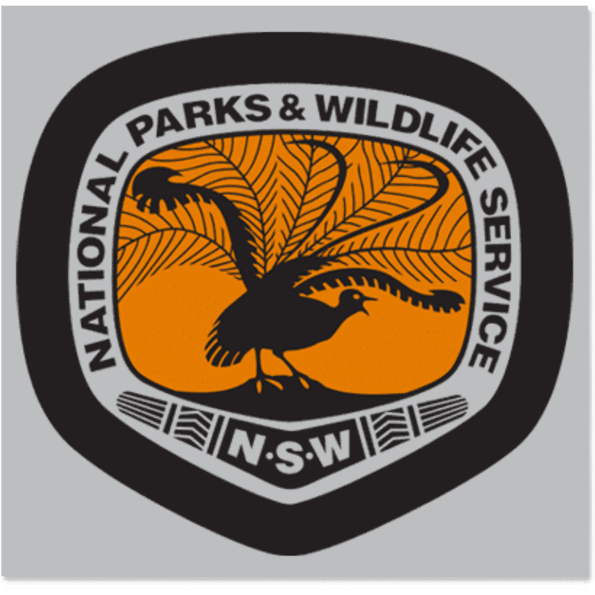 A logo featuring a stylised bird and foliage in orange and black, encased in a shield shape.