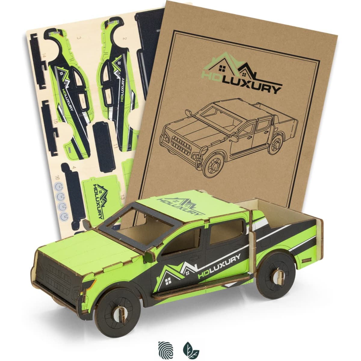 A wooden model of a ute in green and black, accompanied by assembly pieces and packaging.