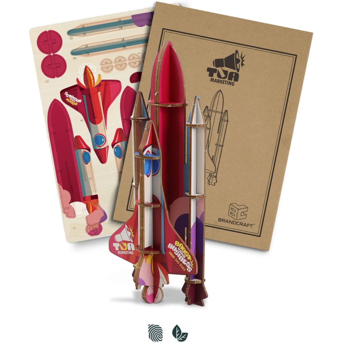 A colourful wooden model rocket kit in shades of red and pink, accompanied by assembly instructions and printed parts.