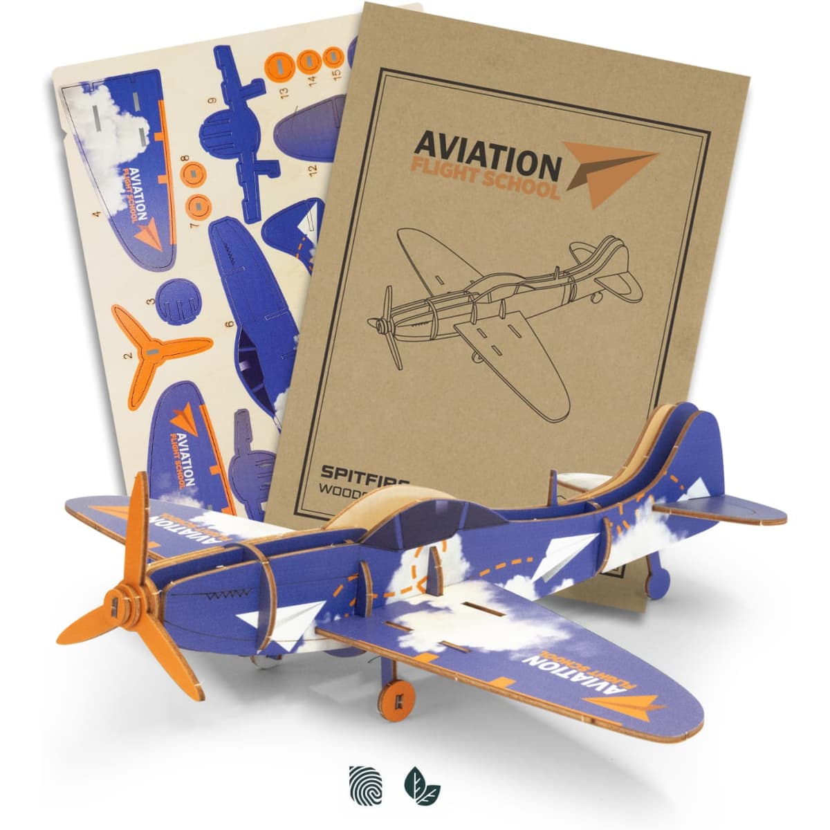 A wooden model of a Spitfire aircraft in blue and orange, accompanied by assembly sheets and flight school materials.