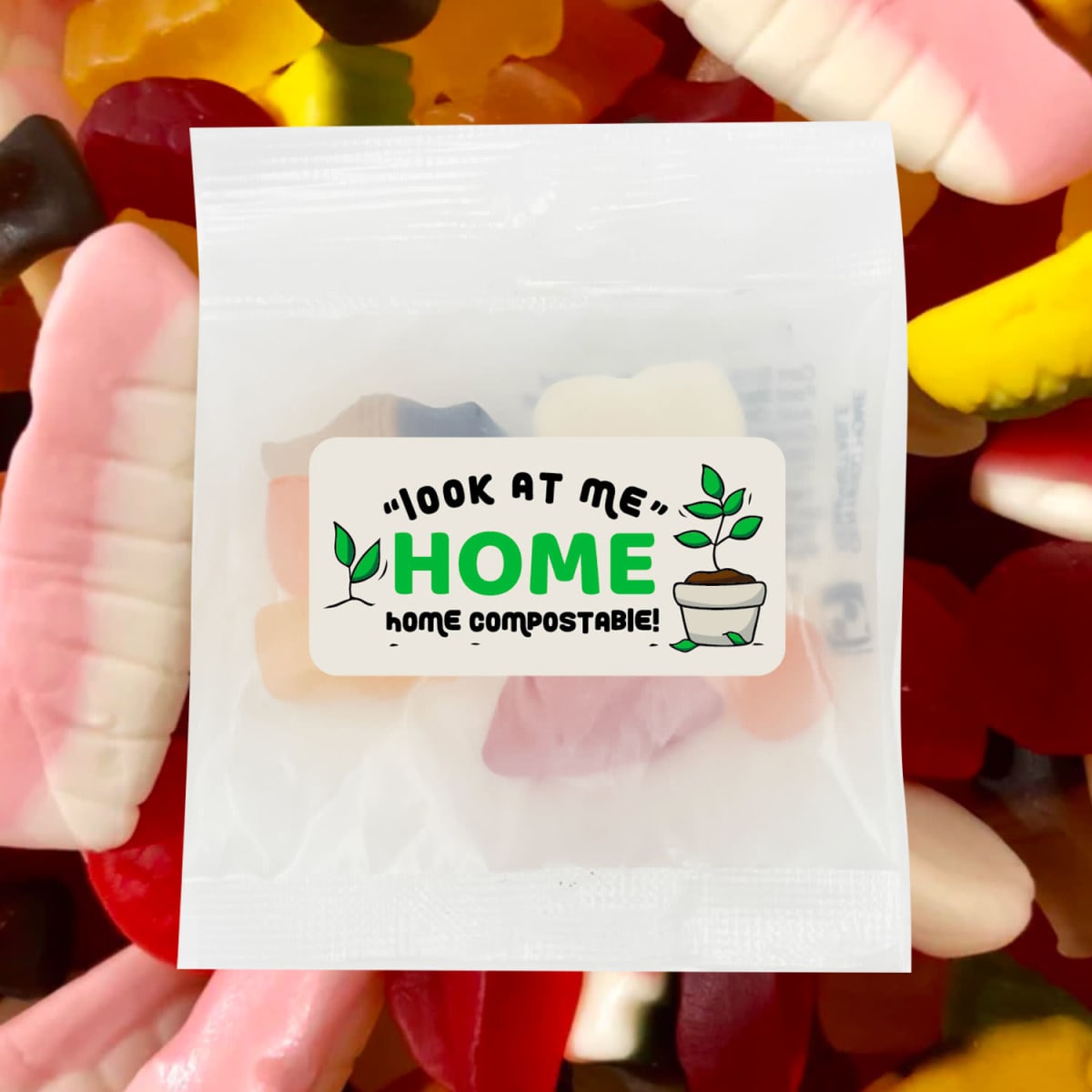 A packet of mixed lollies featuring various colourful gummy shapes, with a compostable packaging label.