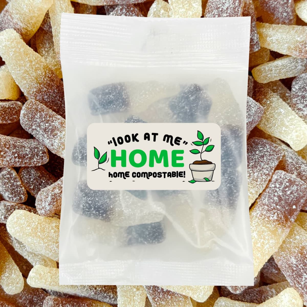 A pack of ECO Sour Cola Bottles, featuring soft, chewy sweets in brown and beige, with a compostable label.