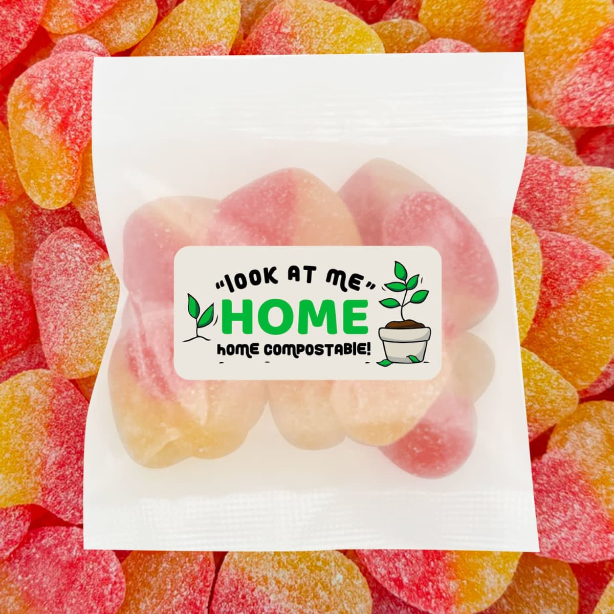 A sealed packet of ECO Sour Peach Hearts in pastel pink and yellow, surrounded by gummi lollies. The packet has a logo.