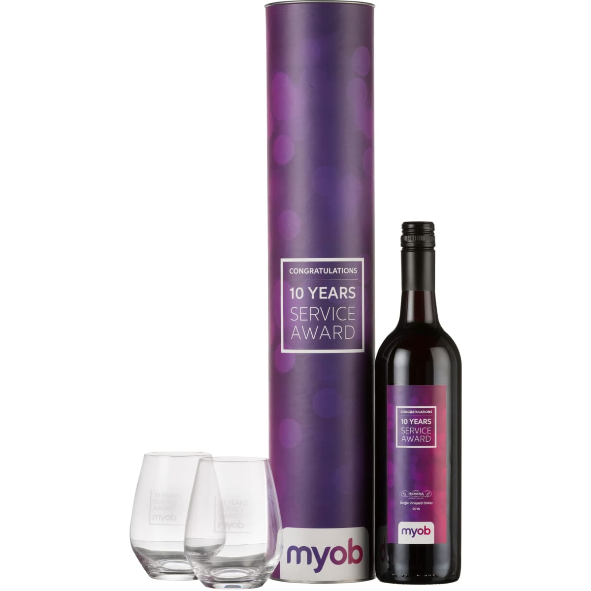 A cylindrical gift box in purple containing a bottle of red wine and two clear stemless glasses, featuring a logo.