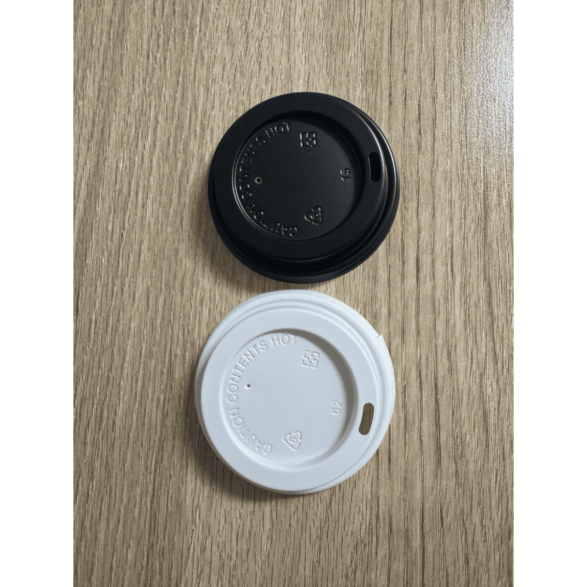 A drink bottle lid set featuring a black lid and a white lid, both designed for 8oz containers.