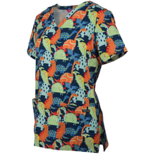 A scrub top featuring a vibrant dinosaur print in green, orange, and blue hues with a pocket. It has a logo.