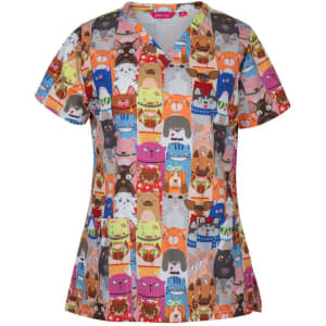 A colourful scrub top featuring a vibrant array of animal faces in various styles and accessories, with a logo.