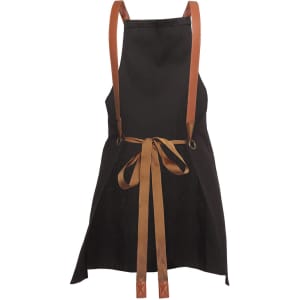 A black apron with brown cross-back straps and a tied bow at the waist. It features branding on the fabric.