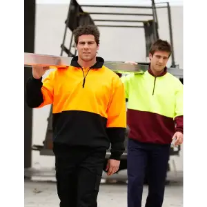 A half-zip polar fleece in bright orange and black, worn by a man carrying a ladder, with another in yellow and maroon.