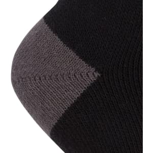 A close-up of a black sock with a grey toe and heel, featuring a logo.