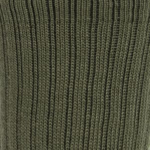 A close-up of a green knitted sock featuring a ribbed texture. The sock is part of a three-pack.