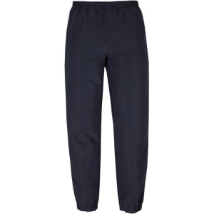 Track pants in navy blue featuring an elastic waistband and cuffed ankles. Includes a logo on the side.