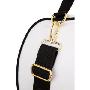 A close-up of a black strap with gold hardware attached to a white bag, featuring a logo on the surface.