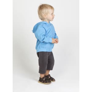 A light blue zip hoodie for babies, paired with dark grey shorts and sandals, displayed on a child standing sideways.