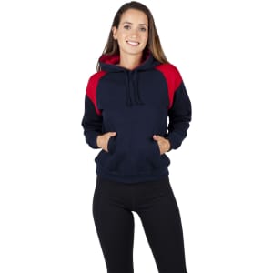A woman wearing a navy and red shoulder contrast panel hoodie with a pocket and hood. The hoodie has a logo.