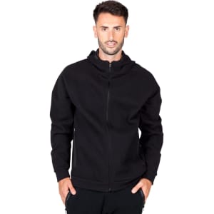 A black hoodie with a front zip and a hood, featuring a logo on one side. The model is wearing it.