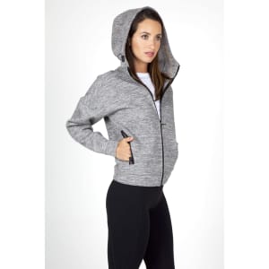 A grey women's hoodie with a zip, featuring a hood and side pockets, worn by a model.