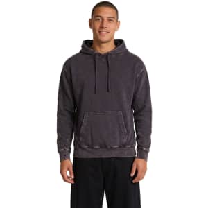 A dark stone wash fleece hoodie with a front pouch pocket and a drawstring hood, worn by a smiling model.