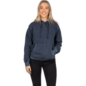 A woman wearing a navy stone wash fleece hoodie with a kangaroo pocket and drawstring hood.
