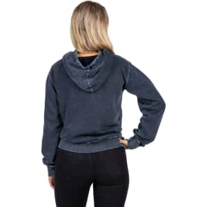 A navy stone wash fleece hoodie with a kangaroo pocket and a hood, modelled by a smiling woman.