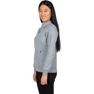 A woman wearing a grey half zip fleece jumper, featuring a fitted design and a logo on the front.