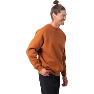 An adults' cotton care sweatshirt in a warm orange colour, featuring a simple design and a logo on the front.