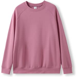 A pink sweatshirt with a classic crew neck and long sleeves, featuring a simple design and a logo.