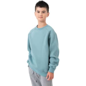 A boy wearing a light blue cotton sweatshirt, paired with grey sweatpants, standing against a white background.