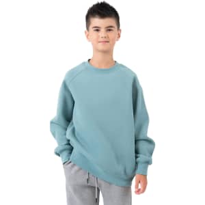 A cotton sweatshirt in a soft teal colour, worn by a child with styled hair and a relaxed expression.