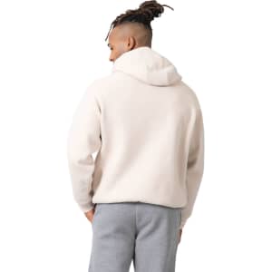 A men's kangaroo hoodie in cream with a hood, featuring a rounded back and a relaxed fit.